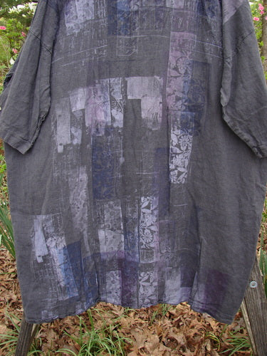 Barclay Linen Oversized Canyon Dress in Floral Cityscape Black, featuring a pattern with purple patches, rounded neckline, drop shoulders, and three-quarter dolman sleeves, showcasing a unique, vintage-inspired design.