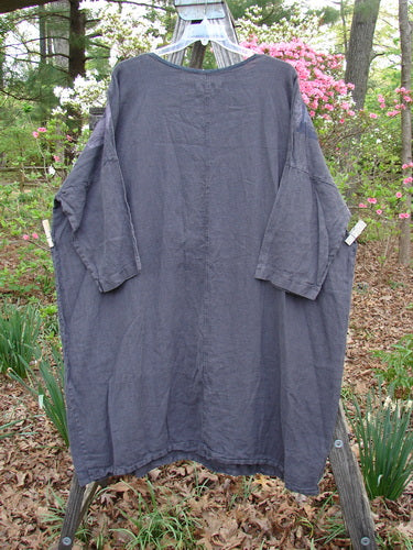 Barclay Linen Oversized Canyon Dress, Floral Cityscape Black OSFA, displayed on a clothesline, highlighting its three-quarter dolman sleeves and generous straight shape, embodying Bluefishfinder.com's vintage, creative style.