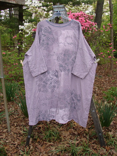 Barclay Linen Oversized Canyon Dress Floral Garden Lilac OSFA displayed on a rack, featuring a floral pattern, rounded neckline, and three-quarter dolman sleeves, reflecting Bluefishfinder.com's vintage style.