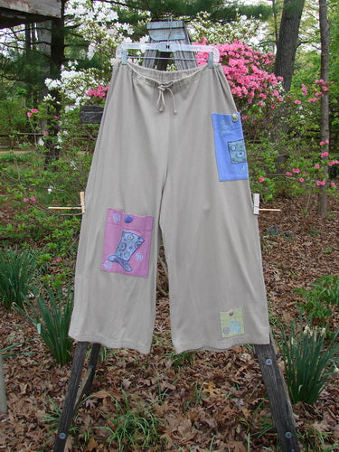 1997 Cubist Pant Top Hat Wheat Altered Size 1 featuring patchwork designs, oversized pockets with vintage buttons, and a full drawstring waistline, embodying Blue Fish's creative, vintage style.