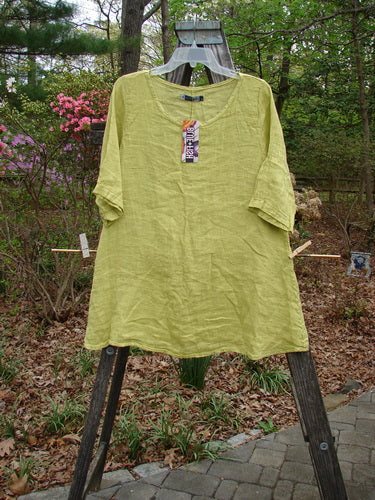 Barclay NWT Linen Springtime Top in Citron on clothes rack, showcasing its rounded neckline, flowy A-line shape, and almost three-quarter length sleeves, reflecting Bluefishfinder.com's vintage-inspired clothing ethos.