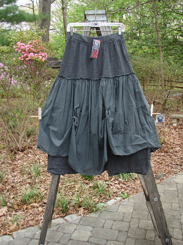 Barclay NWT Linen Batiste Fusion Pant Skirt Unpainted Ironworks Size 0 hangs outdoors, showcasing its layered overpiece with tie accents and tapered pant design, embodying Bluefishfinder.com's vintage, artistic style.