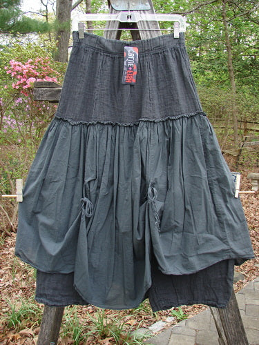 Barclay NWT Linen Batiste Fusion Pant Skirt Unpainted Ironworks Size 0 displayed outdoors, showcasing its full elastic waistline, tie accents, and contrasting under pant with sectional panels, embodying Bluefishfinder's unique vintage style.