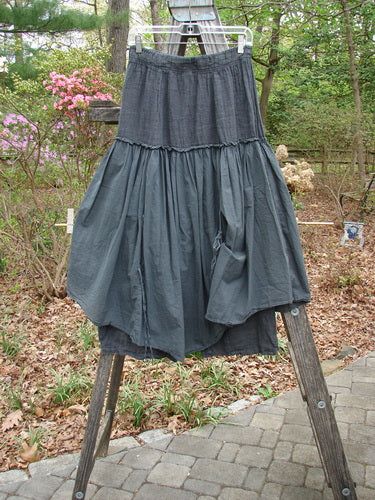 Barclay NWT Linen Batiste Fusion Pant Skirt Unpainted Ironworks Size 0 displayed on a wooden rack outdoors, showcasing its elastic waistline and layered design with tie accents.