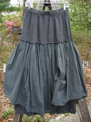 Barclay NWT Linen Batiste Fusion Pant Skirt Unpainted Ironworks Size 0 draped over a fence, showcasing its full elastic waistline and unique layered design with tie accents.
