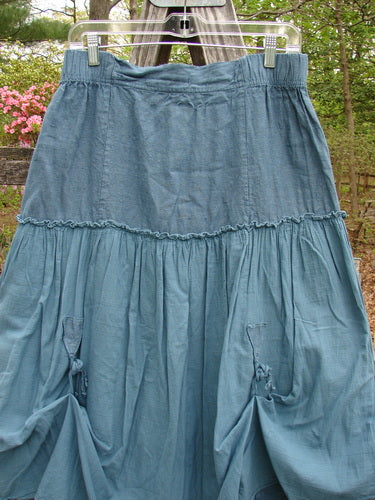 Barclay Linen Batiste Fusion Pant Skirt Unpainted Teal Size 0 displayed on a clothes rack, featuring elastic waist, triangular patches, and double tie accents, embodying BlueFishFinder's vintage fashion ethos.