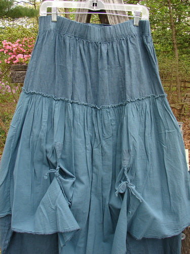 Barclay Linen Batiste Fusion Pant Skirt Unpainted Teal Size 0, hanging on a clothesline, showcases dual tie accents, a flattened front with elastic waist, and a layered design.