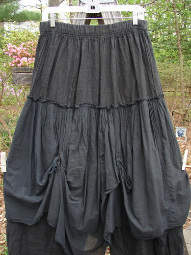 Barclay Linen Batiste Fusion Pant Skirt Galaxy Black Size 0 displayed on a rack, showcasing its unique double tie accents and layered design, perfect for expressing individual style.