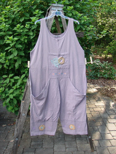 1997 Farmer Brown Overall Ocean Life Jasmine OSFA displayed on a wooden ladder, showcasing its whimsical painted bushel pockets, wide paneled legs, and vintage ocean-themed design, epitomizing BlueFishFinder's vintage, playful style.