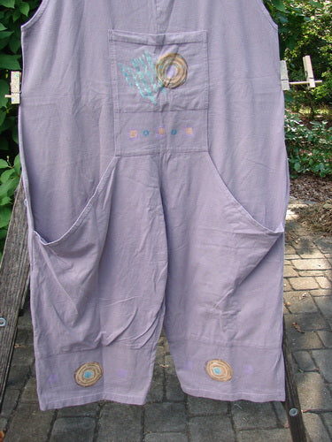 1997 Farmer Brown Overall Ocean Life Jasmine OSFA hanging on a clothesline, showcasing wide lower paneled legs and a whimsically painted dual front bushel pocket, embodying playful comfort in vintage style.