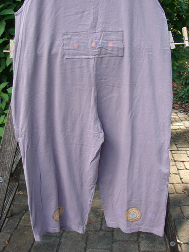 1997 Farmer Brown Overall Ocean Life Jasmine OSFA displayed on a clothesline, showcasing wide swingy legs, whimsically painted dual bushel pocket, and vintage ocean theme paint, crafted from organic cotton.
