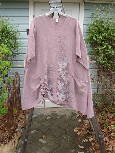 Barclay Linen High Vent Venetian Dress Celtic Fern Lavender Size 1 displayed on a clothes hanger, showcasing its A-line shape, softly dipped V neckline, and Celtic fern design.