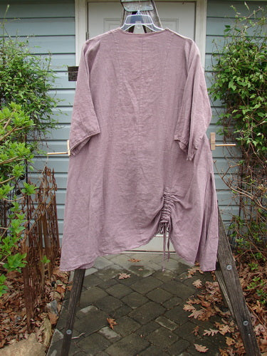 Barclay Linen High Vent Venetian Dress Celtic Fern Lavender Size 1 displayed on a clothes rack, featuring an A-line shape, high side vents, and a softly dipped V neckline.