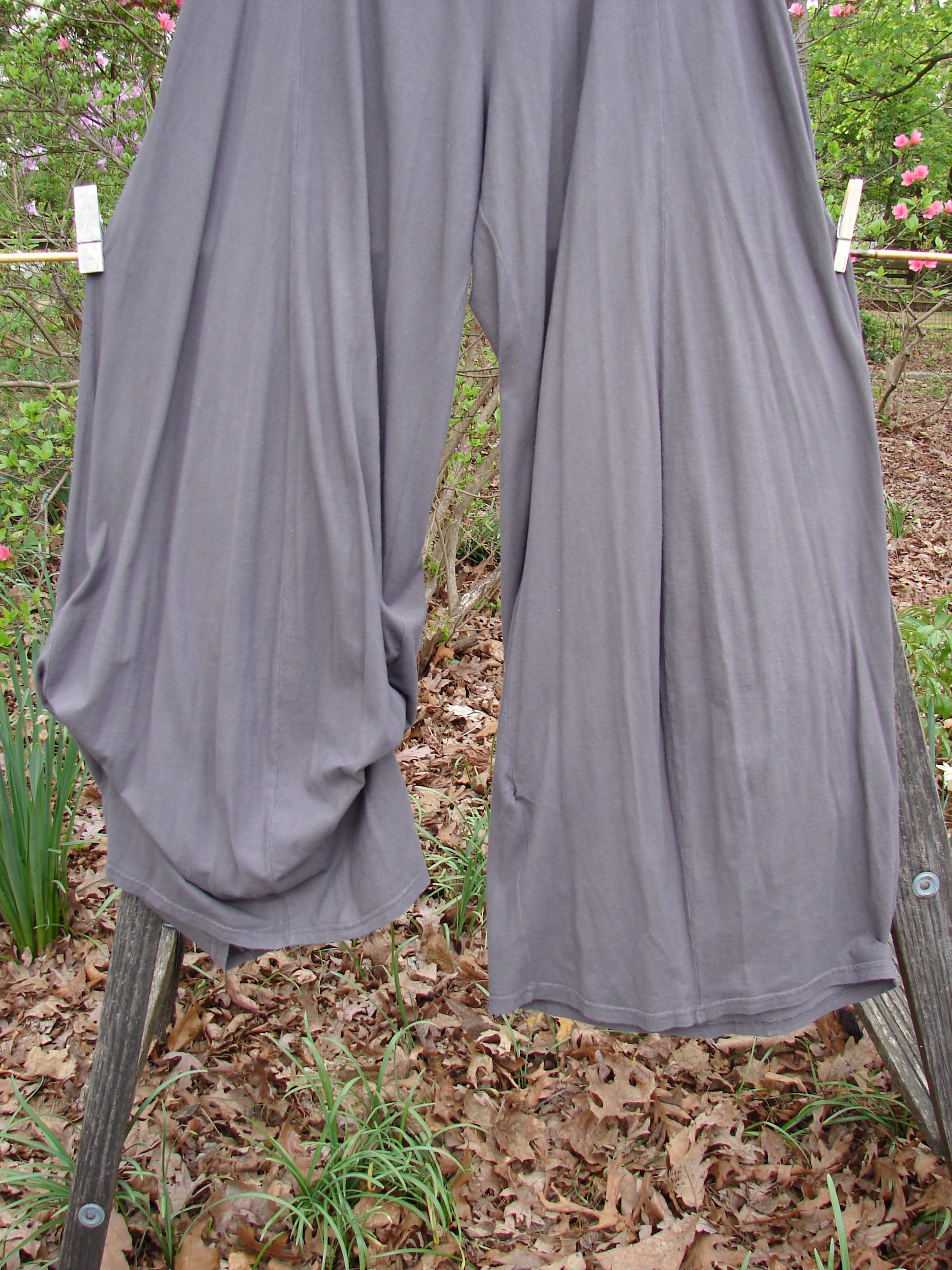 Barclay Lightweight Tie Bottom 4 Square Pant in Unpainted Grey Granite hangs on a clothesline, showcasing its billowing design and elastic waistline, ideal for mixing and matching with other pieces.
