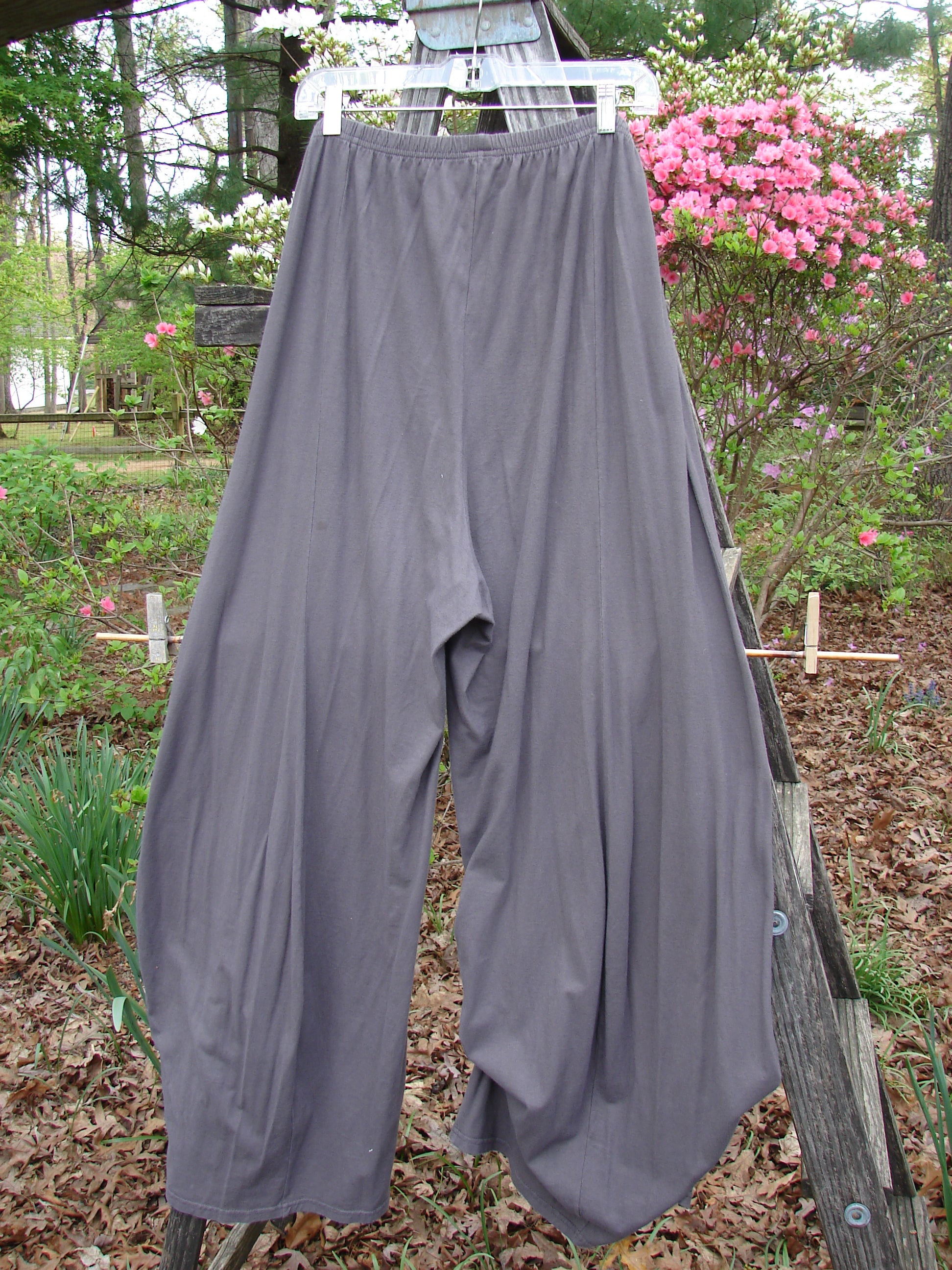 Barclay Lightweight Tie Bottom 4 Square Pant in Grey Granite, hanging on a clothesline outdoors, showcasing its flowing design and elastic waist, from Bluefishfinder.com's Vintage Blue Fish Clothing collection.