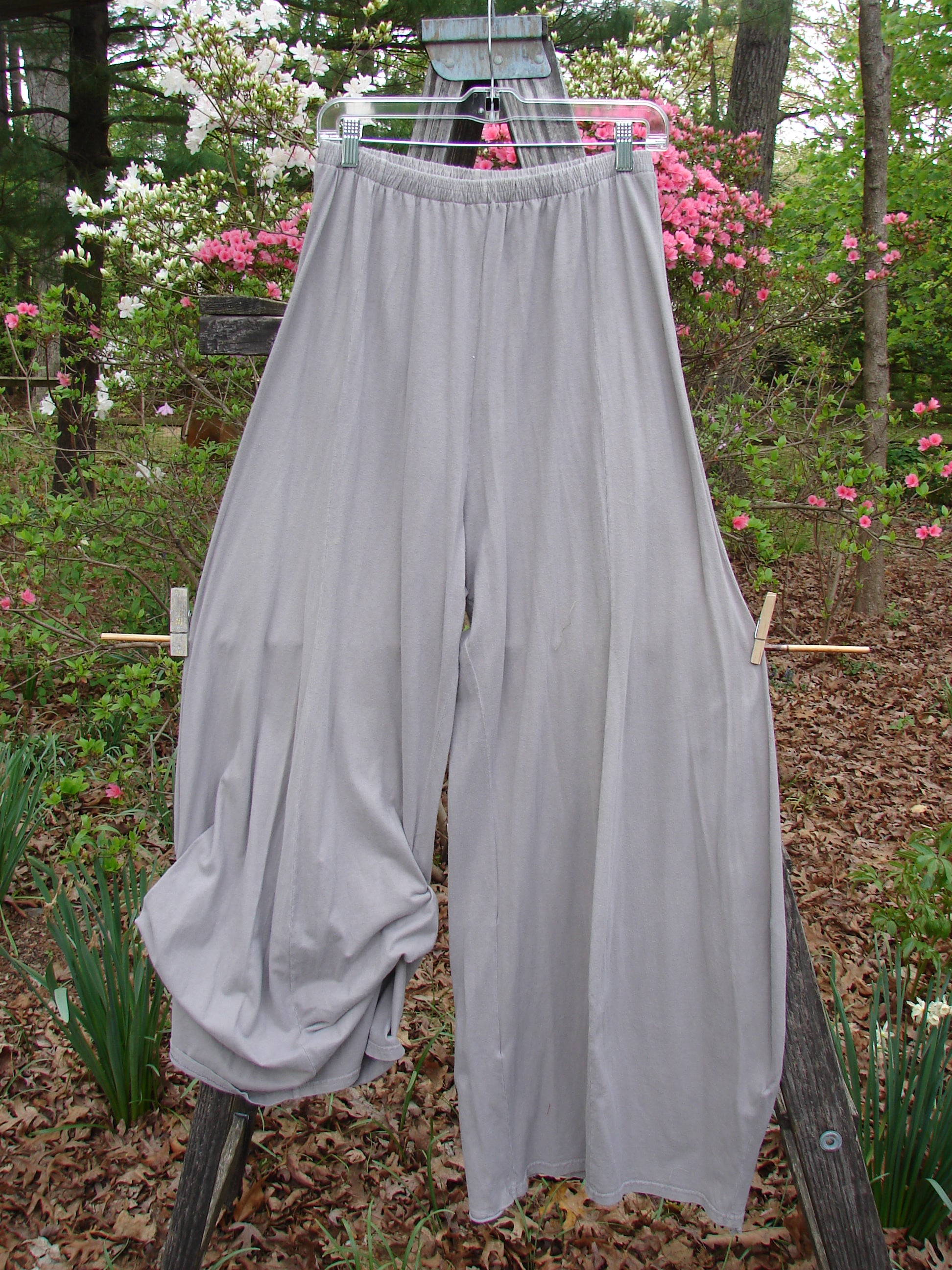 Barclay Lightweight Tie Bottom 4 Square Pant Unpainted Sand Size 0 hanging on a clothesline in a garden, showcasing its billowy lower fall and pocketless drape, reflecting Bluefishfinder.com's unique vintage style.