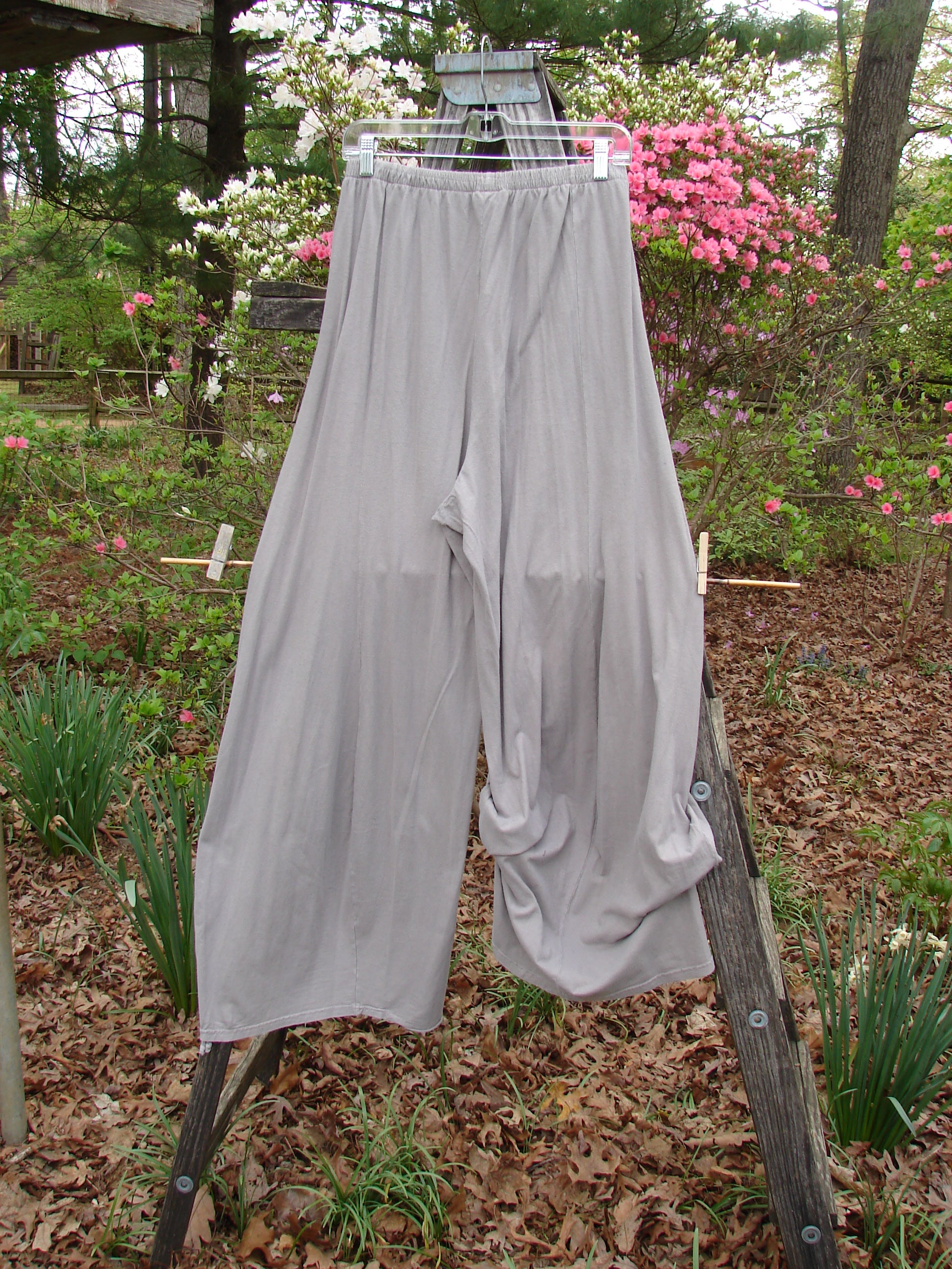 Barclay Lightweight Tie Bottom 4 Square Pant in Sand, hanging on a clothesline outdoors, showcasing its unique design and billowy shape, ideal for versatile styling from Bluefishfinder.com.