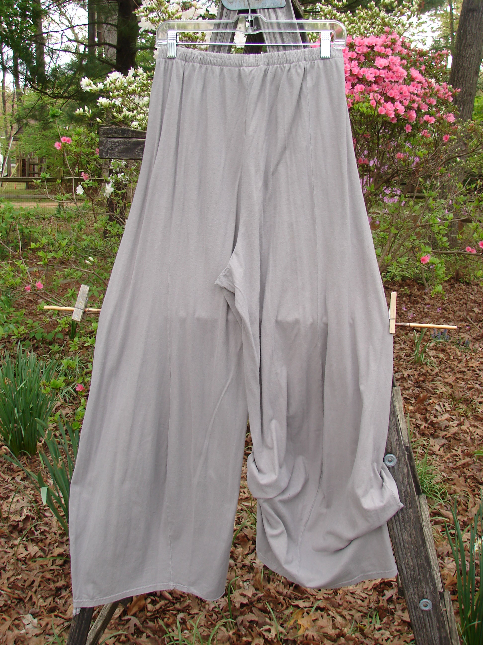 Barclay Lightweight Tie Bottom 4 Square Pant Unpainted Sand Size 0, displayed on a clothesline, showcases its elastic waistline and billowing lower fall, crafted from lightweight organic cotton.