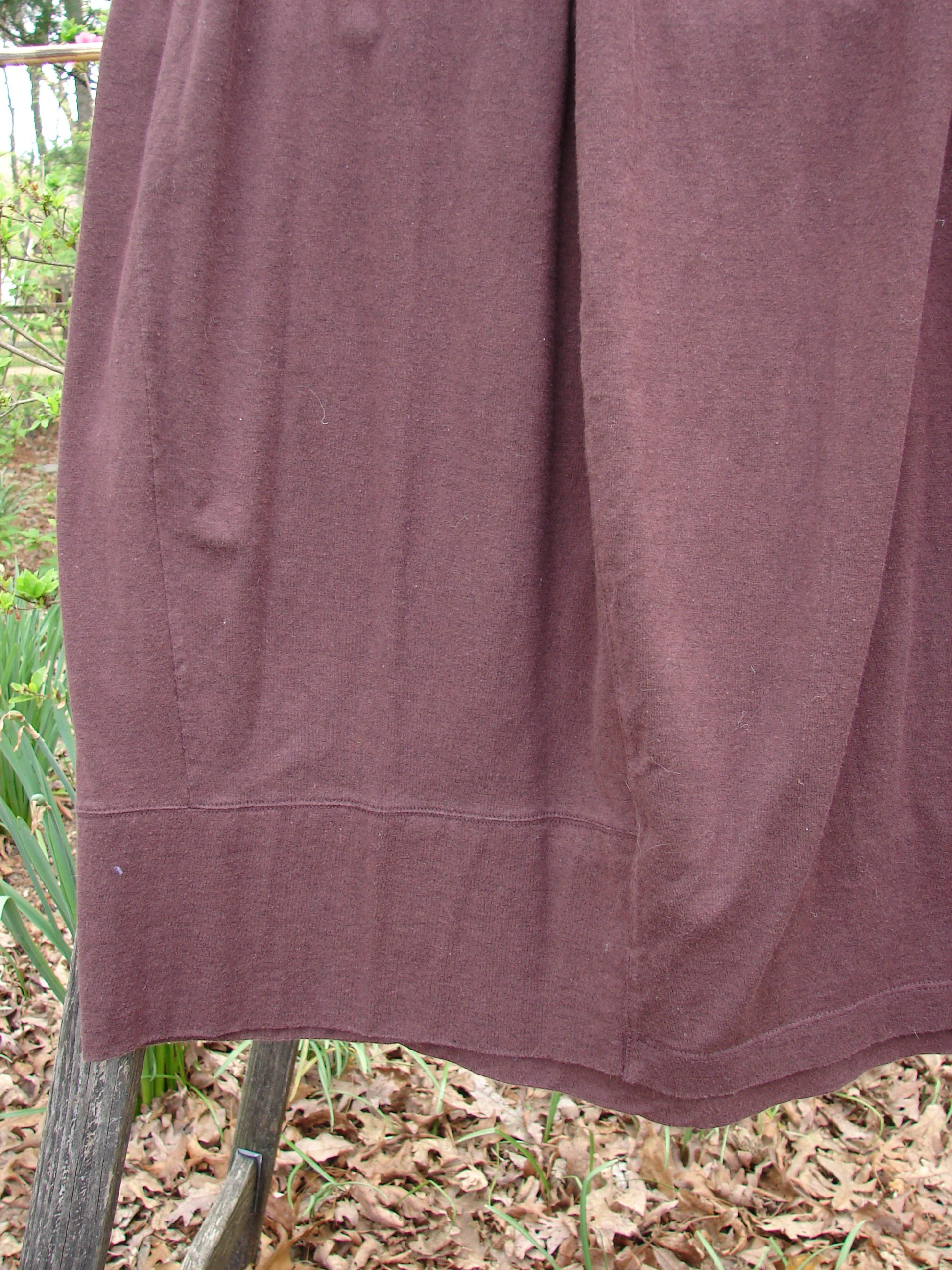 1998 Wool Merino Pria Skirt Unpainted Raisin Size 1, featuring a flattened front waistline, elastic back, and unique four squarish lower shape with sectional panels and diagonal horizontal seams.