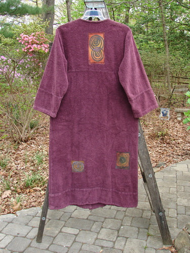 The 2000 Patched Chenille Side Wrap Robe Turn Time Murple Size 0, displayed on a wooden rack, features a unique wrap front, oversized drop pocket, and wide double panel sleeves, exemplifying BlueFishFinder's vintage charm.