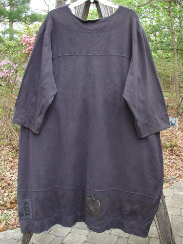 2000 Interlock Glassgow Coat Dress Celtic Black Size 2 hanging, showcasing oversized buttons, a painted bottom panel, and a V-shaped neckline, embodying Bluefishfinder.com's vintage, expressive style.