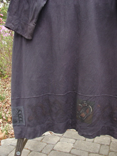 2000 Interlock Glassgow Coat Dress Celtic Black Size 2 showcasing oversized buttons and a wide swingy hem with Celtic-themed paint, highlighting its vintage style and unique design details.
