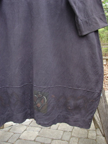 Close-up of the 2000 Interlock Glassgow Coat Dress Celtic Black Size 2, showcasing its V-shaped neckline, oversized buttons, and distinctive Celtic theme paint details. Ideal for vintage Blue Fish Clothing enthusiasts.