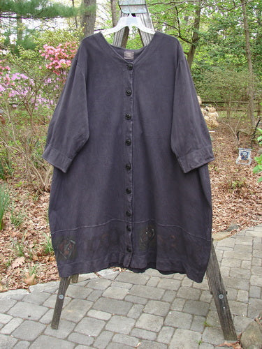 2000 Interlock Glassgow Coat Dress Celtic Black Size 2 displayed on a swinger, showcasing its full front line of oversized buttons, swingy hem, and classic Celtic theme paint, embodying vintage Blue Fish style.