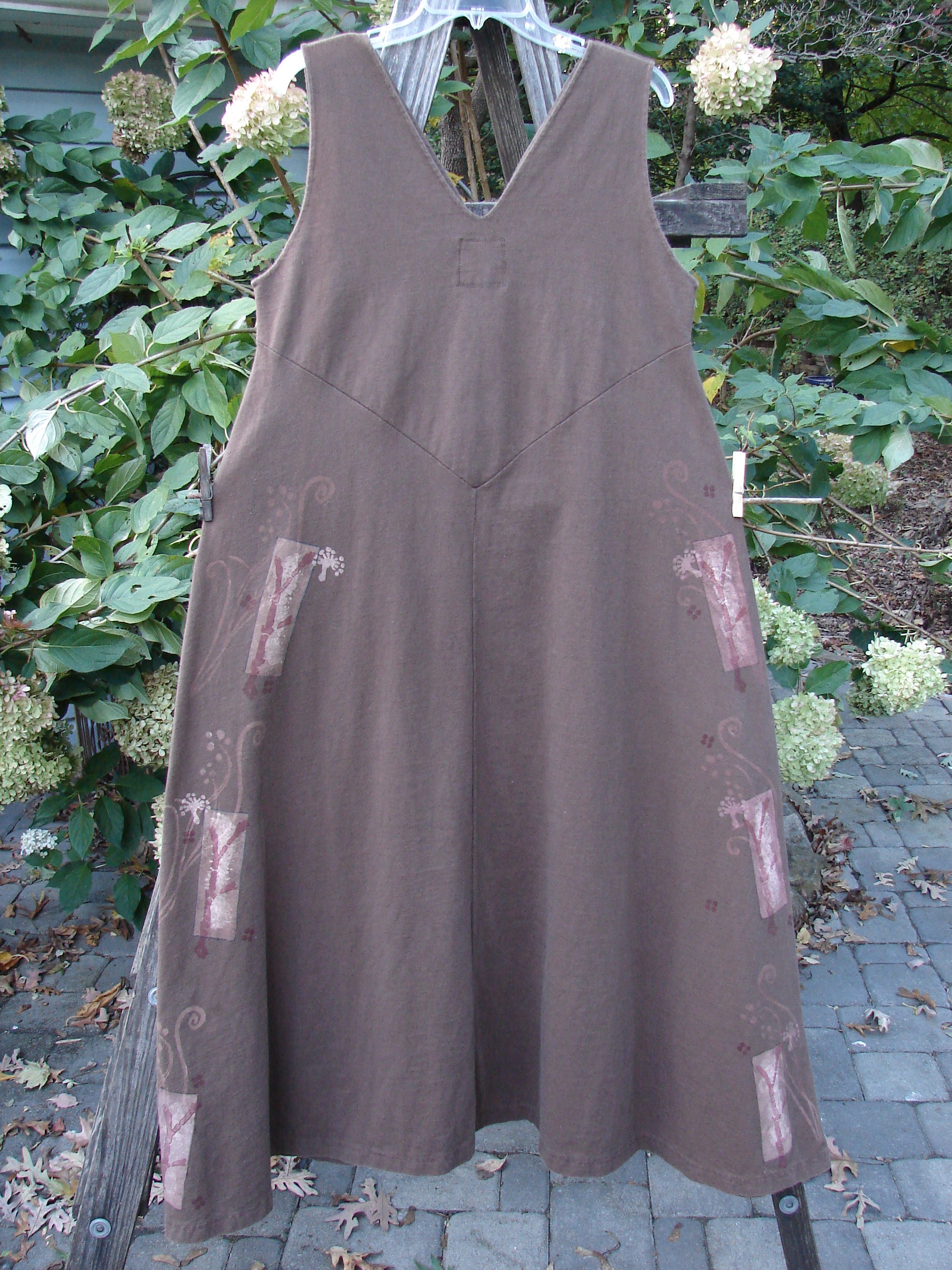 1997 Charmer's Jumper Magic Forest Mandorla Size 1: Mid-weight organic cotton dress with sleeveless jumper style, A-line flair, keyhole front, and Magic Forest theme design, hanging outdoors on a line.
