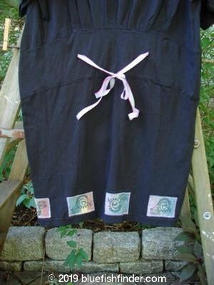 1992 Patched Little Storma Dress in Black Small OSFA featuring a deep rounded neckline, downward curved front waist seam, gathered top half rear with hand-dyed silk ribbon, and music-themed patches.