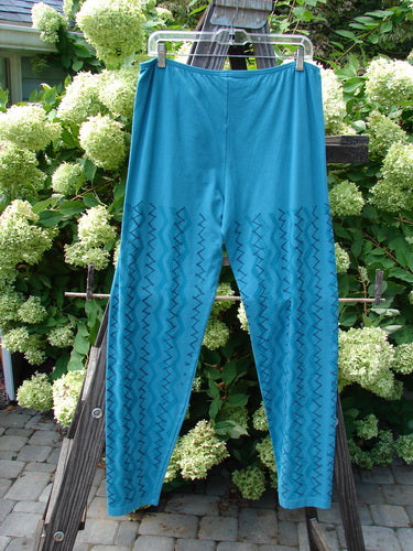 Barclay Cotton Lycra Bally Layering Pant Legging Continuous Criss Cross Aqua Size 2 displayed on a clothes rack, featuring a zigzag pattern and full elastic waistband.