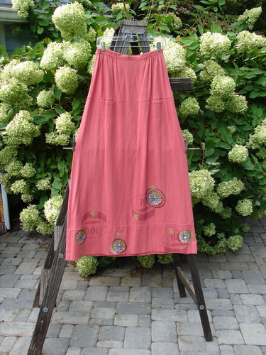 1998 Scrabble Skirt Games Cerise Size 2 displayed on a wooden stand, showcasing its waistline with flat folded front, horizontal panels, and lower banded wider sweep with two upper finger pockets.