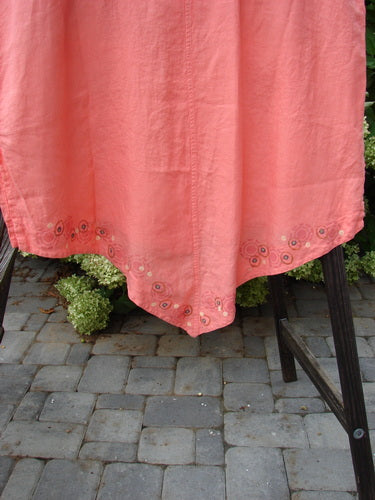 Barclay Linen Katy Vest Circle Spin Tangerine Size 2 displayed on a stand, showcasing its oval neckline, thick pearly buttons, and varying hemline with a center point rear.