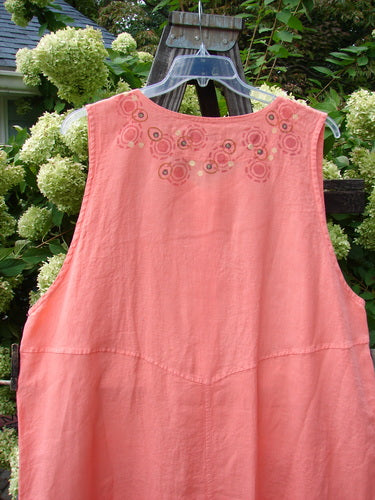 Barclay Linen Katy Vest Circle Spin Tangerine Size 2 on a swinger, featuring thick pearly buttons, oval neckline, painted drop pockets, and unique hemline with center rear point.