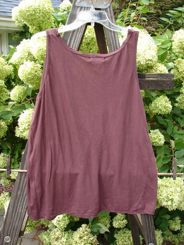 Barclay NWT Batiste Decora Tiny Tank Unpainted Bordeaux Size 2 displayed on a wooden rack, featuring a slight A-line shape, vertical neckline tie, and diagonal insert.