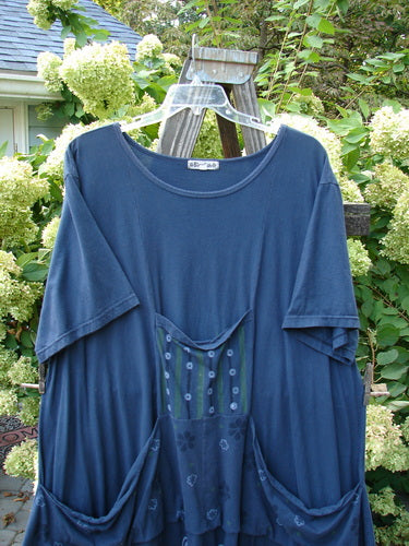Barclay Farmer Jen Tunic Dress Shell Flower Navy Size 2 displayed on a wooden rack, showcasing front drop pockets and a deep rounded neckline.