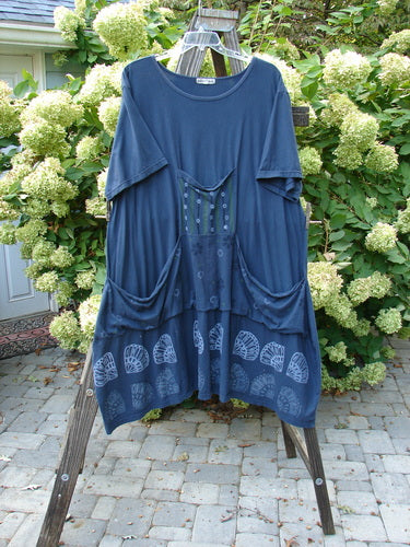 Barclay Farmer Jen Tunic Dress Shell Flower Navy Size 2 displayed on a rack, showcasing its unique shell flower pattern and generous, flowing design with front drop pockets.
