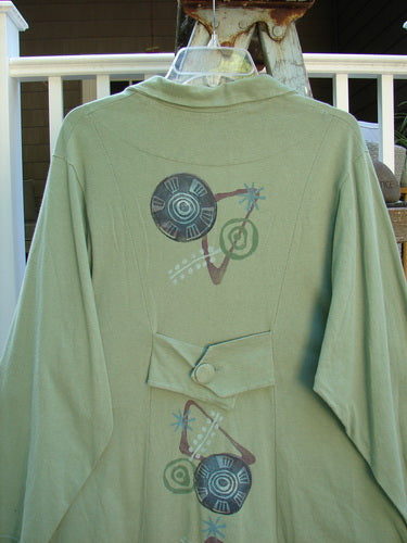 1996 Boulevard Jacket Giant Pinwheel Spanish Moss Size 0: A green jacket with a design on it. Features include a button accented and cut collar, button tabbed back, varying shirttail hemline, and two side pockets. Great tailored look for any Blue Fish Collector!