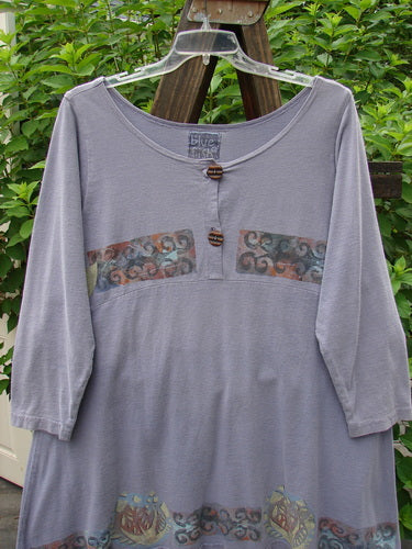 1993 Sparrow Dress Continuous Celtic Periwinkle OSFA displayed on a hanger, showcasing downward yoked waist seam, two wooden button upper closure, varying hemline, and vintage banded mixed patterns.