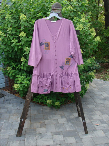 Image alt text: 1997 Belladonna Jacket in Geranium, a purple jacket with a whimsical top hat theme paint and a flirtatious bottom flounce.