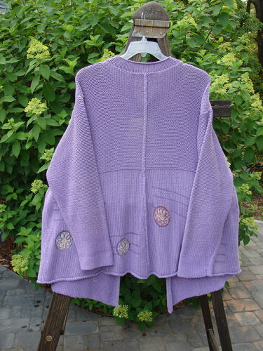 1999 Rollneck Cardigan Sweater Pinwheel Viola OSFA: A purple sweater with lovely pinwheel designs and a shiny porcelain button.