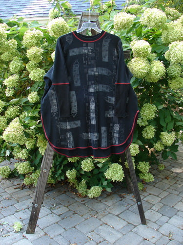 Barclay Thermal Contrast Revival Top Continuous Cityscape Black OSFA displayed on a rack, featuring long sleeves with ribbed accents, a rounded neckline, and a unique cityscape paint design.