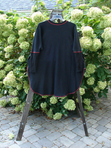 Barclay Thermal Contrast Revival Top Continuous Cityscape Black OSFA displayed on a wooden stand, featuring ribbed accents, tapered sleeves, and a rounded neckline with a cityscape theme.