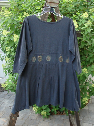 1993 Sage Dress Bountiful Black Size 1 displayed on a hanger, featuring a downward curved front waistband, double pleats, and a varying hemline with a painted harvest theme.