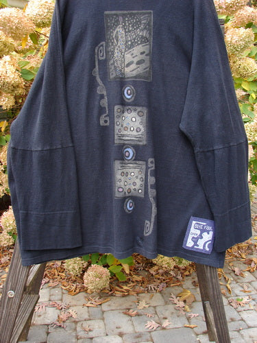 1995 Reprocessed Deco Jacket Polka Gal Black OSFA, featuring a dense cotton texture, double button hole, drop dolman shoulders, and oversized painted pockets, displayed on a rack.