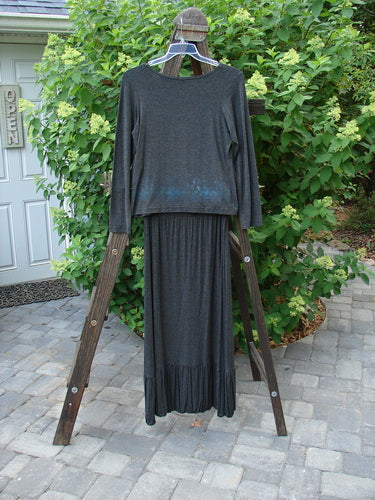 2000 Rayon Lycra Midi Bubble Trio Sparkle Border Charcoal Size 1 2: A clothes rack with a long sleeved top and bubble skirt on a wooden ladder.