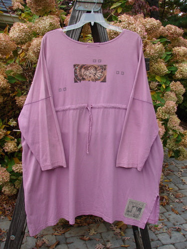 1997 Collage Top Petal Power Crocus OSFA: A purple shirt on a swinger, featuring an A-lined shape, drop shoulders, vented sides, and oversized front pockets with vintage knot buttons. Made from mid-weight organic cotton.