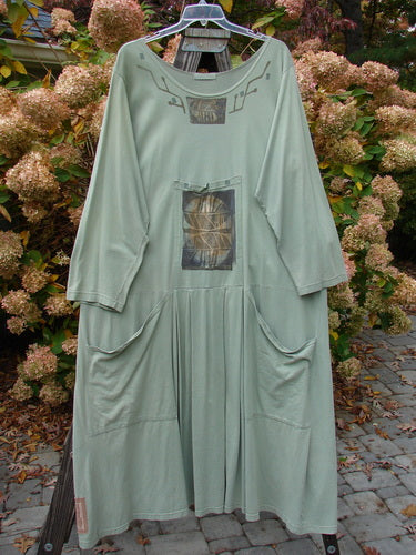 1995 Farmer Jen Dress Fall Leaves Dinette Green Size 2, featuring a medium-weight cotton jersey, wider neckline, long sleeves, center pleats, multiple pockets including a signature Blue Fish patch.