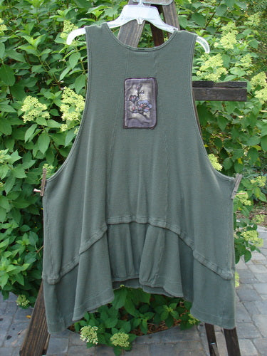 Barclay Thermal Patched Susset Vest features a forest green design with a patch, two front pockets, detachable bottom flounce, deep arm openings, wooden buttons, and sectional panels.