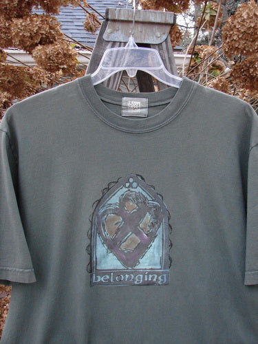 2000 Short Sleeved Tee Belonging Highland Size 1: A grey t-shirt with a graphic on it, featuring a drawing of a heart.